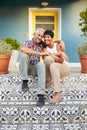 Mature Couple Sitting On Steps Outside House Royalty Free Stock Photo