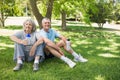 Mature couple sitting with water bottles at park