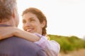 Mature, couple and smile in embrace at sunset with love, trust and support in marriage or partnership. Happy, woman and Royalty Free Stock Photo