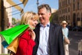 Mature couple strolling through city shopping