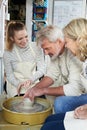 Mature Couple With Teacher In Pottery Class Royalty Free Stock Photo