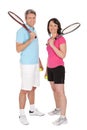 Mature couple with tennis racquets Royalty Free Stock Photo