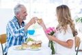 Mature couple toasting wineglass in restaurant