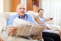Mature couple together with newspaper Royalty Free Stock Photo