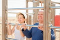 Mature couple together training on pull-up bar