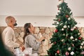 Mature couple, tree decorating and Christmas celebration in living room, family home and house for happy celebration Royalty Free Stock Photo