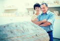 Mature couple turists examines basrelief of tomb in historical museum Royalty Free Stock Photo