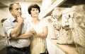 mature couple turists examines basrelief of tomb in museum Royalty Free Stock Photo