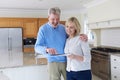 Mature Couple Viewing New Home Standing In Kitchen Looking At Br Royalty Free Stock Photo