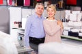 Mature couple are visiting shop of household appliances for surv Royalty Free Stock Photo