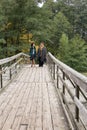 Mature couple walking on the wooden bridge. Casual wear. True l