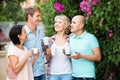 Mature couples walking and drinking coffee on holiday