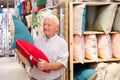 Mature customer buying pillow in store Royalty Free Stock Photo