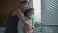 Mature daughter visiting senior mom in nursing home. Elderly daughter hugs her 90 year old mother in medical mask while Royalty Free Stock Photo