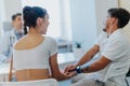 Doctors Discussing Clinical Outcomes with a Happy Couple Undergoing Therapy at a Clinic