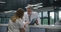 Mature doctor discusses work with nurse at reception Royalty Free Stock Photo