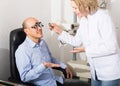 Mature doctor examinating eyesight