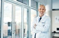 Mature doctor, leadership and portrait with arms crossed in hospital feeling proud from medical work. Healthcare Royalty Free Stock Photo