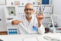 Mature doctor man holding model of human anatomical skin and hair pointing finger to one self smiling happy and proud Royalty Free Stock Photo