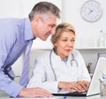 Manager and doctor reading news Royalty Free Stock Photo