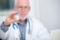 Mature doctor with pill in hospital Royalty Free Stock Photo