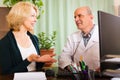 Mature doctor talking with aged female patient Royalty Free Stock Photo