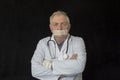 Mature doctor with tape across his mouth Royalty Free Stock Photo