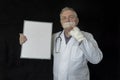 Mature doctor with tape across his mouth Royalty Free Stock Photo