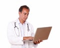 Mature doctor working on his laptop Royalty Free Stock Photo