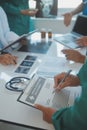 Mature doctors and young nurses stacking hands together at hospital. Close up hands of medical team stacking hands. Group of Royalty Free Stock Photo