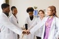 Mature doctors and young nurses stacking hands together at hospital. Close up hands of medical team stacking hands Royalty Free Stock Photo