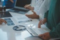 Mature doctors and young nurses stacking hands together at hospital. Close up hands of medical team stacking hands. Group of Royalty Free Stock Photo