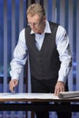 Mature engineer, architect or businessman standing at a desk Royalty Free Stock Photo