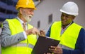 Engineer discussing the structure of the building with architects colleague at construction site. Engineers with document Royalty Free Stock Photo