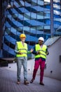 Engineer discussing the structure of the building with architects colleague at construction site Royalty Free Stock Photo
