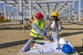 Mature Engineer and Female Architect Checking the Construction Blueprint on Construction Site Royalty Free Stock Photo