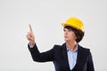 Mature engineer lady in hard hat indicating