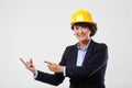 Mature engineer lady in hard hat indicating