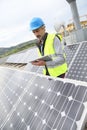 Mature engineer working on the roof with tablet