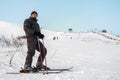 Mature European downhill skier standing on snowy mountain slope and looking at camera, copy space Royalty Free Stock Photo