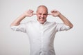 Mature european man closing his ears because of loud sound and noise. I do not want listen to you. Royalty Free Stock Photo