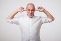 Mature european man closing his ears because of loud sound and noise. I do not want listen to you. Royalty Free Stock Photo