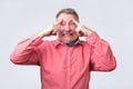 Man holds fingers on temples, trying to remember Royalty Free Stock Photo