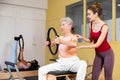 Mature European woman performing an exercise with a special ring