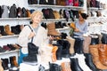 Mature european woman chooses winter boots