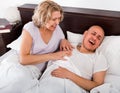 Mature evil girl looking at snoring boyfriend Royalty Free Stock Photo