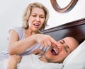 Mature exhausted tired girl looking at snoring boyfriend Royalty Free Stock Photo