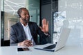 Mature experienced man with headset phone inside office at workplace, smiling talking remotely and advising customers Royalty Free Stock Photo