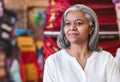 Mature fabric shop owner standing in her colorful store Royalty Free Stock Photo