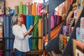 Mature woman doing inventory in her fabric shop Royalty Free Stock Photo